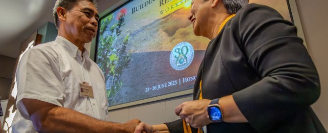 Director Vares-Lum shakes a Fellow’s hand during the graduation ceremony.