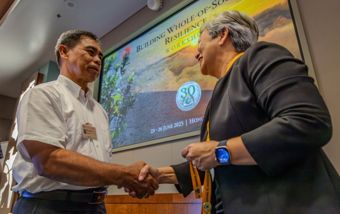 Director Vares-Lum shakes a Fellow’s hand during the graduation ceremony.